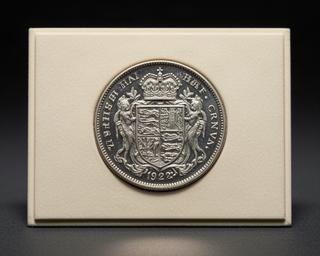 1927 British proof half-crown coin resting on a neutral display mount