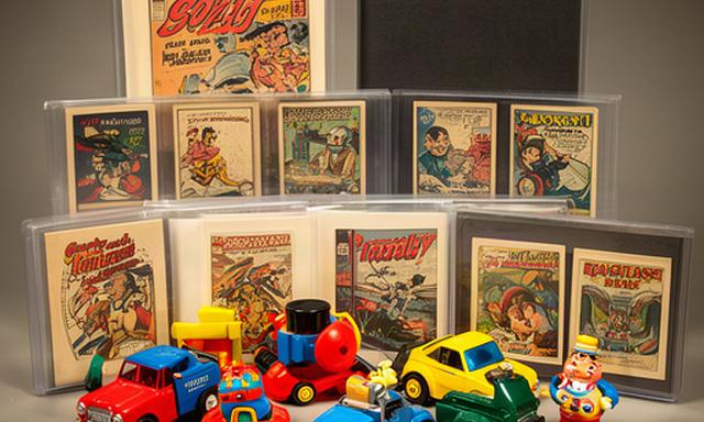 Vintage toys, comic books and trading cards arranged in protective sleeves